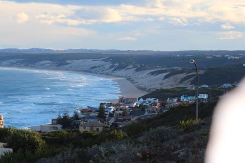 a small town on a hill next to the ocean at Eden Guesthouse B&B in Dana Bay