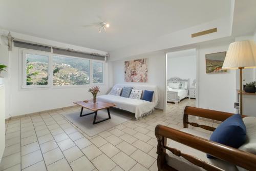 uma sala de estar com um sofá e uma mesa em Victoria's Summerhouse em Andros