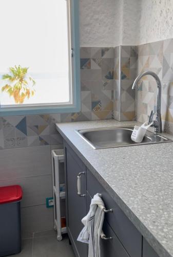 a kitchen with a sink and a counter top at Cabo Negro Appart M&M in Cabo Negro