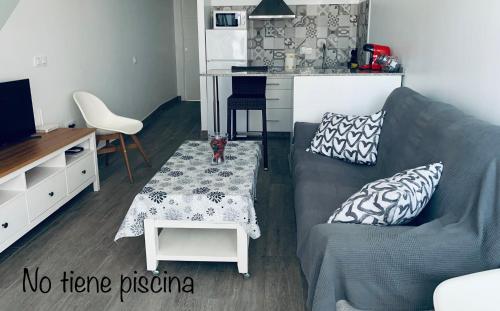 a living room with a couch and a table at HOLIDAY ALYMA in Sanlúcar de Barrameda