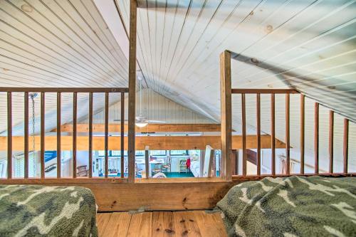 a room with two beds and a staircase in a house at Peaceful Long Pond Cottage with Dock and Views in Rochester