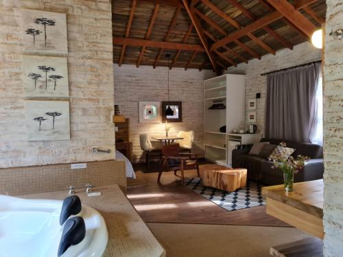 a living room with a couch and a table at Pousada Toca Da Coruja in Monte Verde