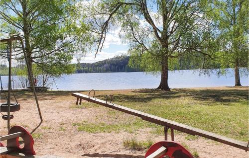 a park bench next to a body of water at 3 Bedroom Beautiful Home In Bullebo in Bullebo