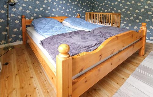 a wooden bed with a wooden frame in a bedroom at 3 Bedroom Beautiful Home In Bullebo in Bullebo