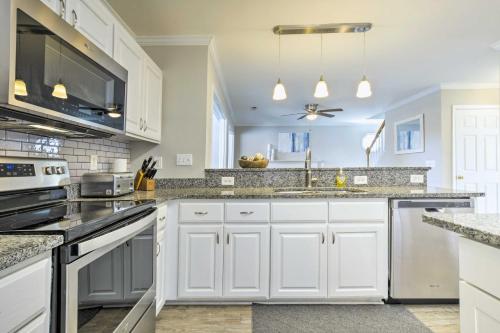a kitchen with white cabinets and a sink at Gorgeous Graham Home with Private Outdoor Pool! in Graham