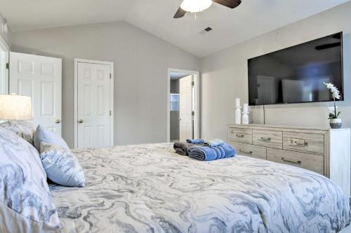 a bedroom with a large bed with a flat screen tv at Gorgeous Graham Home with Private Outdoor Pool! in Graham