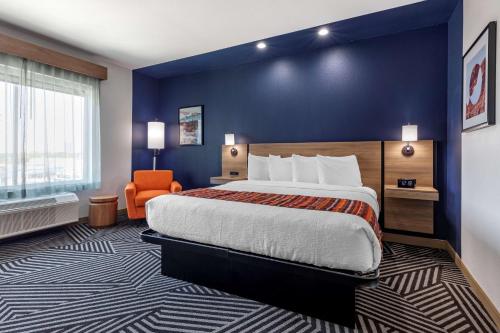 a hotel room with a bed and an orange chair at Best Western Plus Amarillo East Hotel in Amarillo