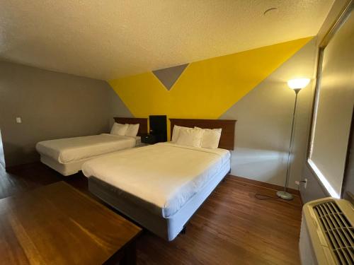 Ένα ή περισσότερα κρεβάτια σε δωμάτιο στο Sunnyside Inn and Suites