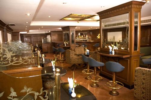 a restaurant with tables and chairs and a bar at The South Park Hotel in Trivandrum