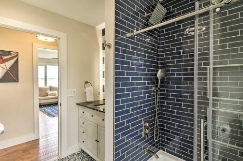 a bathroom with a shower with a blue tile wall at Cambridge Beach Home on Choptank River with Pier! in Cambridge