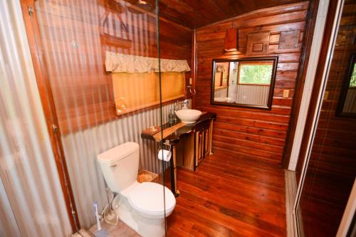 a bathroom with a toilet and a sink at KikiWitz Resort in Belmopan