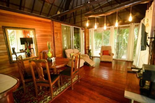 a living room with a table and chairs at KikiWitz Resort in Belmopan