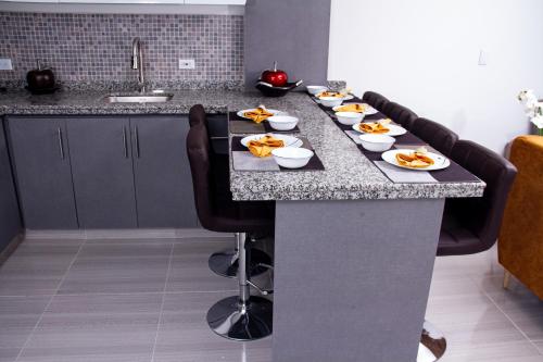 a long table with plates of food on it at HERMOSO APARTAMENTO AMOBLADO CENTRO DE BUGA in Buga