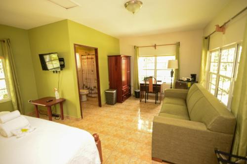 a living room with a couch and a bed at KikiWitz Resort in Belmopan
