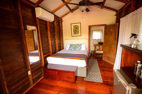 a small bedroom with a bed in a room at KikiWitz Resort in Belmopan