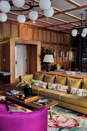 a living room with a couch and a table at The Drayton Hotel Savannah, Curio Collection by Hilton in Savannah