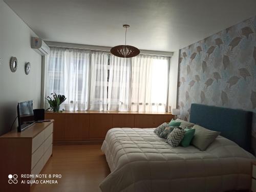 a bedroom with a large bed and a window at Recoleta Beatiful Gran Callao Concord in Buenos Aires