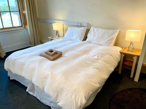 a large white bed with a towel on it at Newington House in Edinburgh