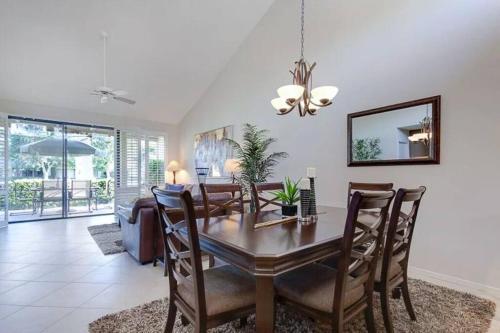 a dining room with a table and chairs at Private Country Club Condo on awesome golf course! in Palm Desert