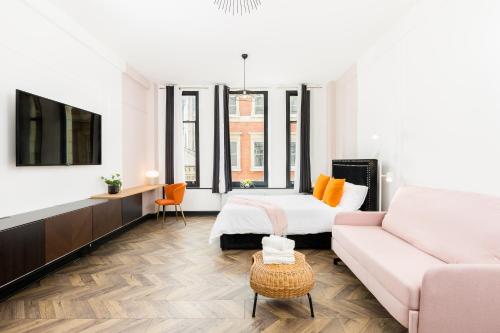 a living room with a bed and a couch at Indigo Apartment in Birmingham