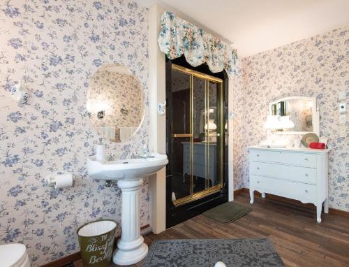 a bathroom with a sink and a mirror at Chez Nous in Cornwall