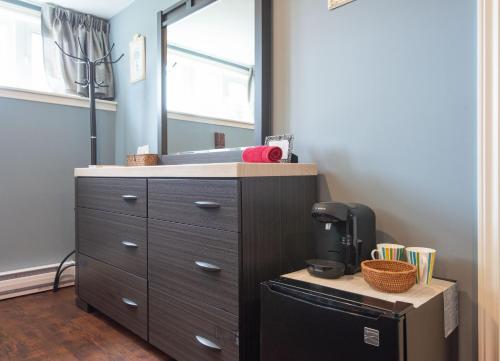 a bathroom with a dresser and a mirror at Chez Nous in Cornwall
