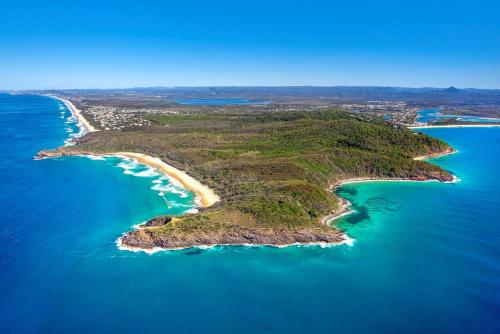 an aerial view of a small island in the ocean at Duke St Convenience at your doorstep Beach living in the heart of the village close to cafes Ocean glimpse in Sunshine Beach