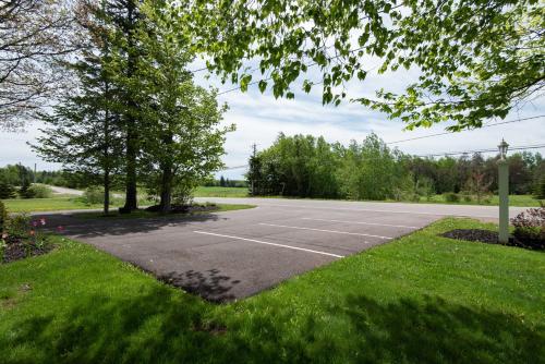 an empty parking lot with trees and grass at Chez Nous in Cornwall
