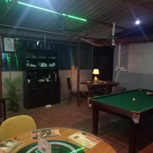 a room with a pool table and a bar at Palms Villa in Negombo