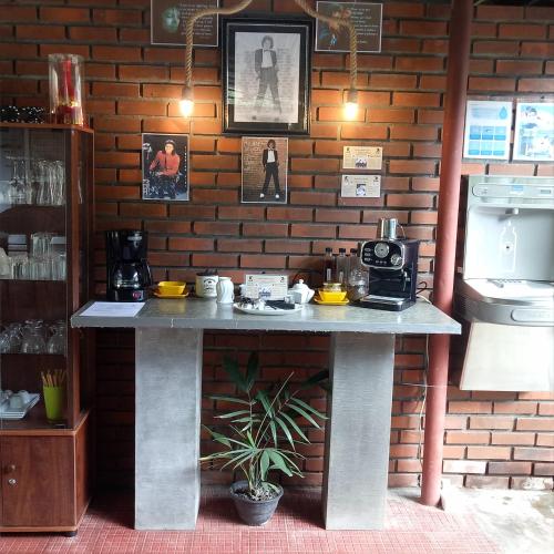 a table in a room with a brick wall at Palms Villa in Negombo