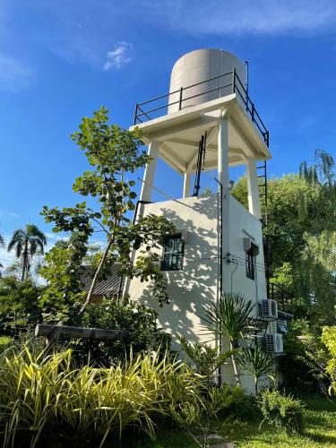 a lighthouse on the side of a building at Chaisuk Bungalow in Aranyaprathet