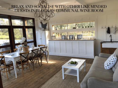 a living room with a couch and a table at Block Eight Estate Gum Trees Villa in Belford