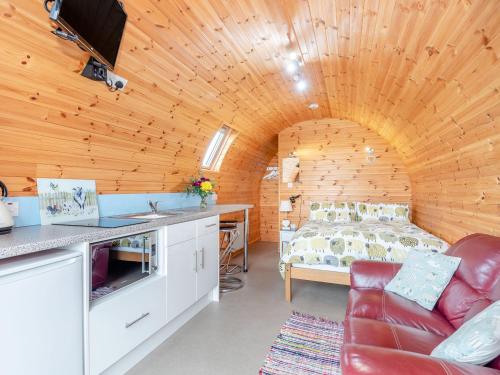 a bedroom with a bed in a wooden room at Ewe Two in Flint