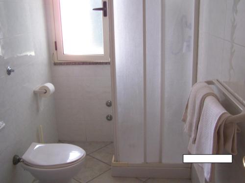 a bathroom with a white toilet and a window at Hotel Nautilus in Nicotera Marina