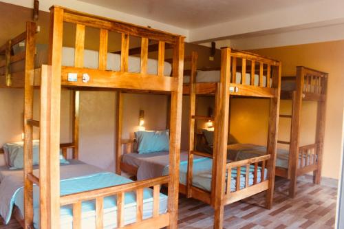 a room with three bunk beds in a room at Ba Be Hostel in Bak Kan