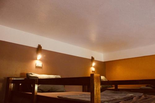 two bunk beds in a room with two lights at Ba Be Hostel in Bak Kan