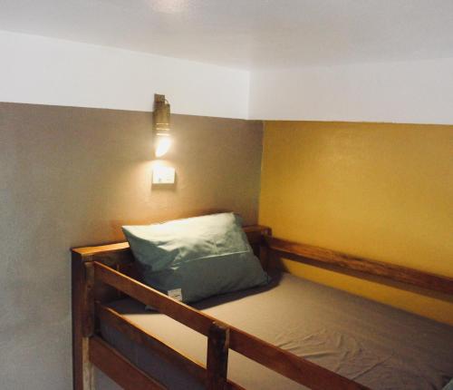 a room with a bed with a light on the wall at Ba Be Hostel in Bak Kan
