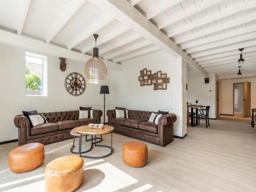 a living room with couches and a table at Spacious Family Holiday Home in Mont-de-l'Enclus