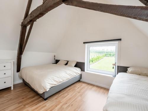 two beds in a bedroom with a window at Spacious Family Holiday Home in Mont-de-l'Enclus