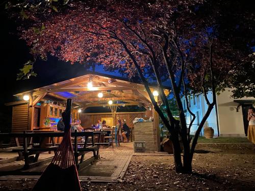 a woman in a hammock in front of a restaurant at night at Agriturismo San Michele in San Michele