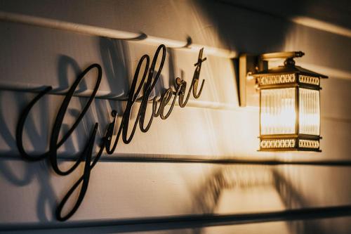 a light on a wall next to a shelf with a lamp at Gilbert by Whiskey June in Maryborough