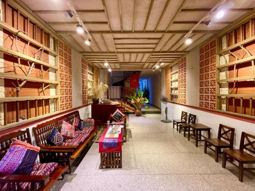 a library with benches and tables in a room with shelves at Lan home- Jeep Tour, Motobike tour, rental motobike, private car Cao Bang in Cao Bằng