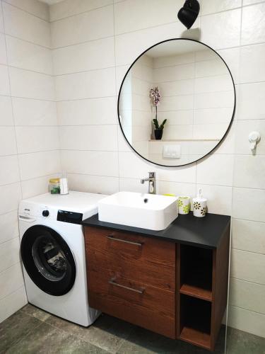 a bathroom with a washing machine and a sink at Bellavista Resort in Koper