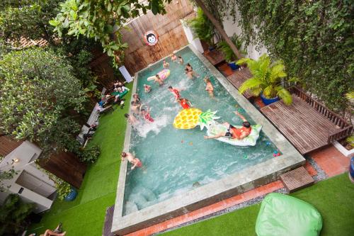 an overhead view of people in a swimming pool at Mad Monkey Hostel Phnom Penh in Phnom Penh