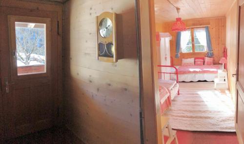 a room with a door and a room with a bedroom at Sonniges Chalet Arosa für 6 Pers alleinstehend mit traumhaftem Bergpanorama in Langwies