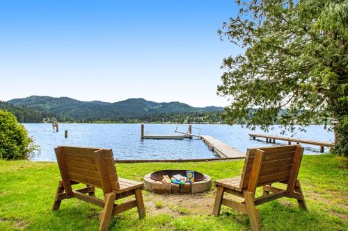 two chairs and a fire pit next to a lake at Silver King in Bellingham