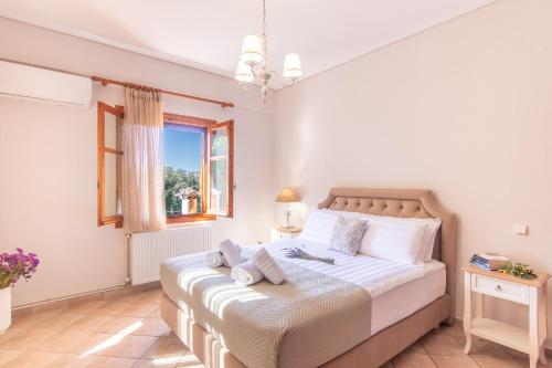 a bedroom with a bed and a window at Pelagia Apartments in Koroni