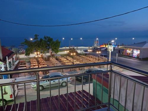 a parking lot with a bunch of tables and cars at Katerina apartment in Nea Plagia