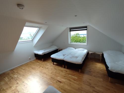 a room with two beds and two windows at Semesterlägenhet Wettervy in Gränna