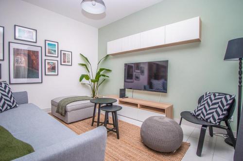 a living room with a couch and a table and chairs at Apartment close to golf, beaches, Quinta Lago, Vale Lobo, Quarteira and Vilamoura in Quinta do Lago
